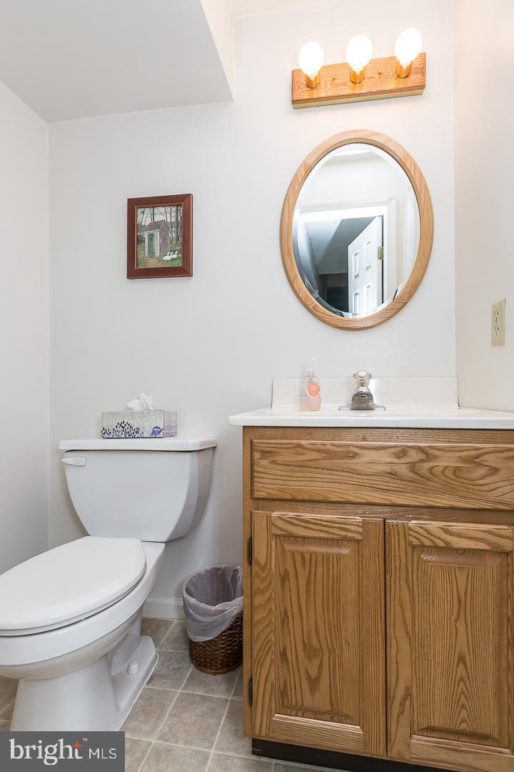 1941 Oak Leaf Lane Holmes, PA 19043 - Photo 20 of 44 a bathroom with a toilet a sink and a mirror