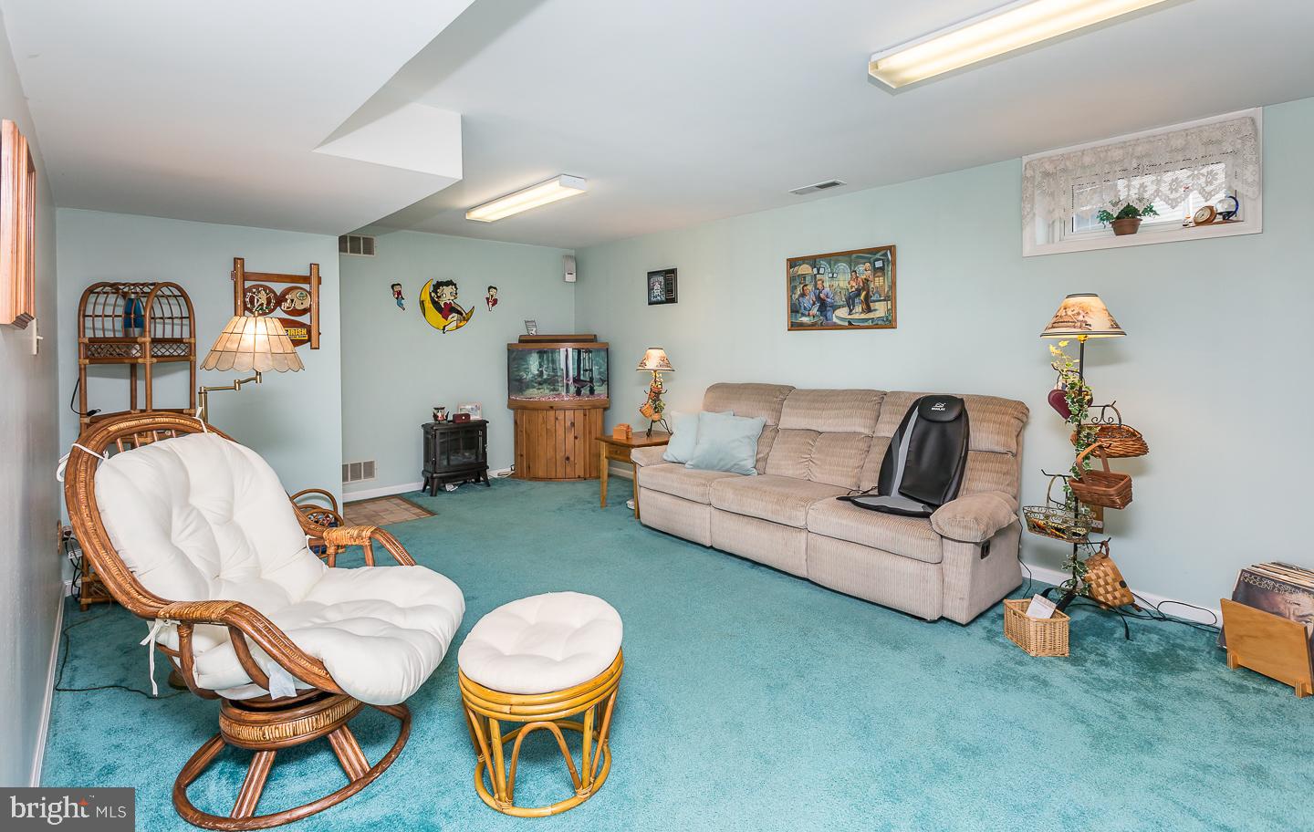 1941 Oak Leaf Lane Holmes, PA 19043 - Photo 30 of 44 a living room with furniture a rug and a wall painting