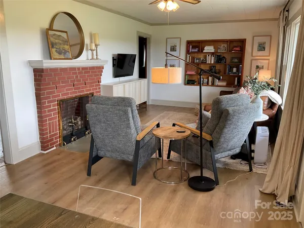 a view of a livingroom with furniture and a fireplace