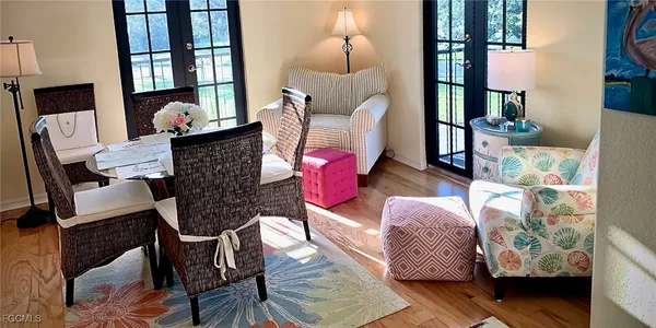 a living room with furniture and wooden floor