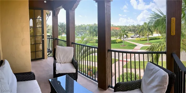 a view of a city from a balcony with furniture