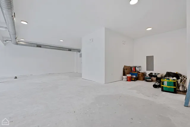 a view of an empty room with window and cabinet