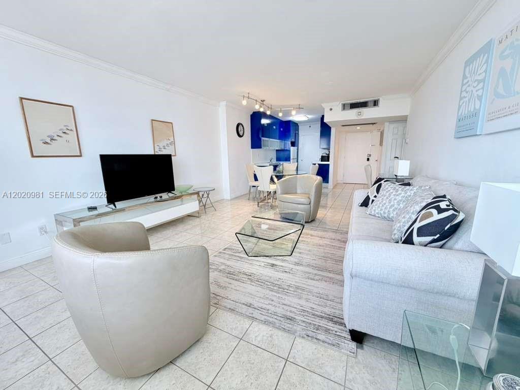 100 Lincoln Road, Unit 1423 Miami Beach, FL 33139 - Photo 3 of 17 a living room with furniture and a flat screen tv