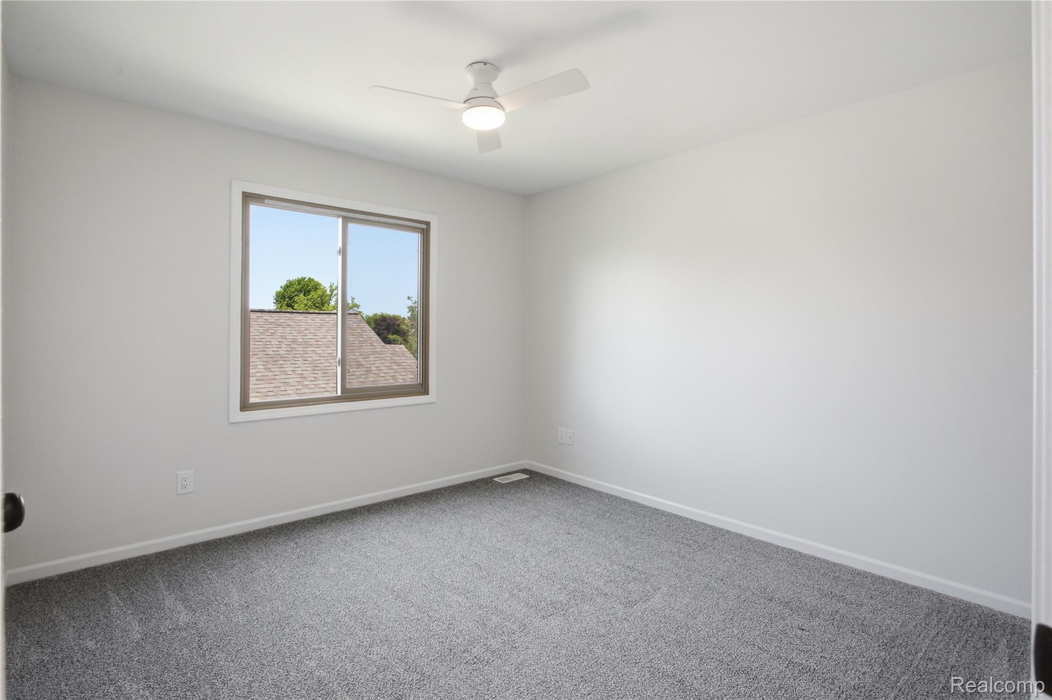 52658 Stag Ridge Drive Macomb, MI 48042 - Photo 27 of 28 Neutral-toned walls complement the gray carpeting