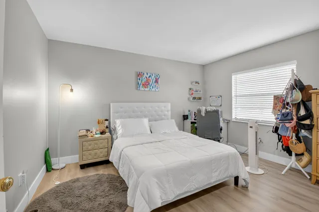 a bedroom with bed and a window