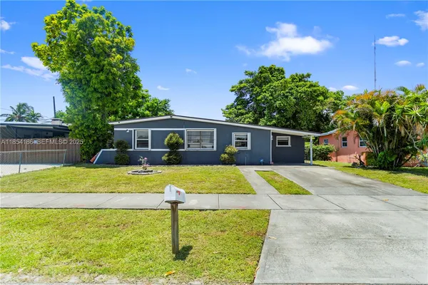 a front view of house with yard and outdoor seating