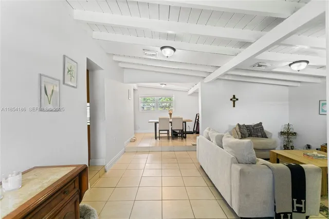 a room with a couch and a washing machine with wooden floor