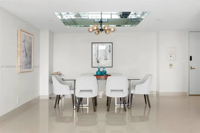 a view of a dining room with furniture and chandelier