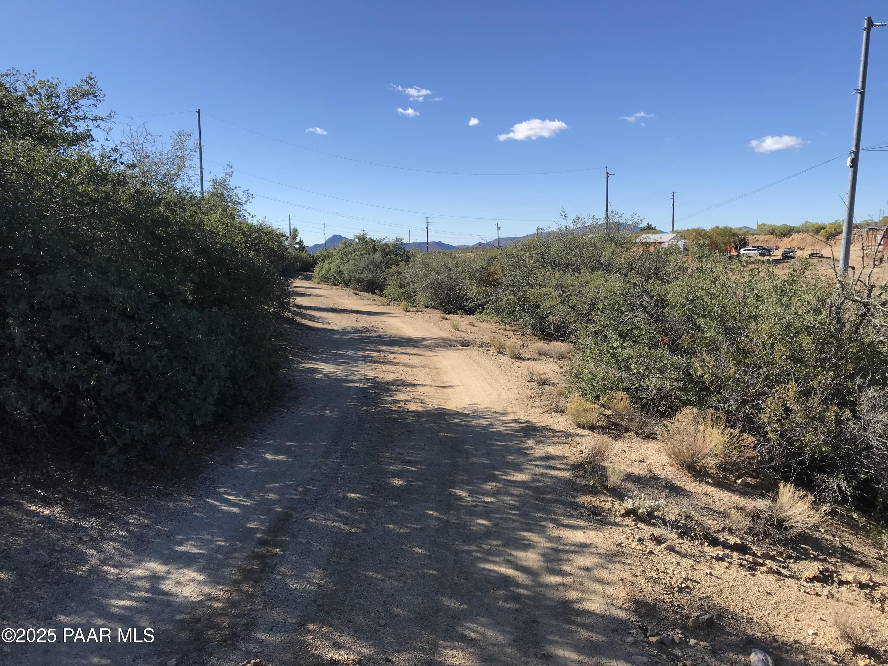 8335 West Barrington Road Wilhoit, AZ 86332 - Photo 3 of 13 a view of a road from a yard