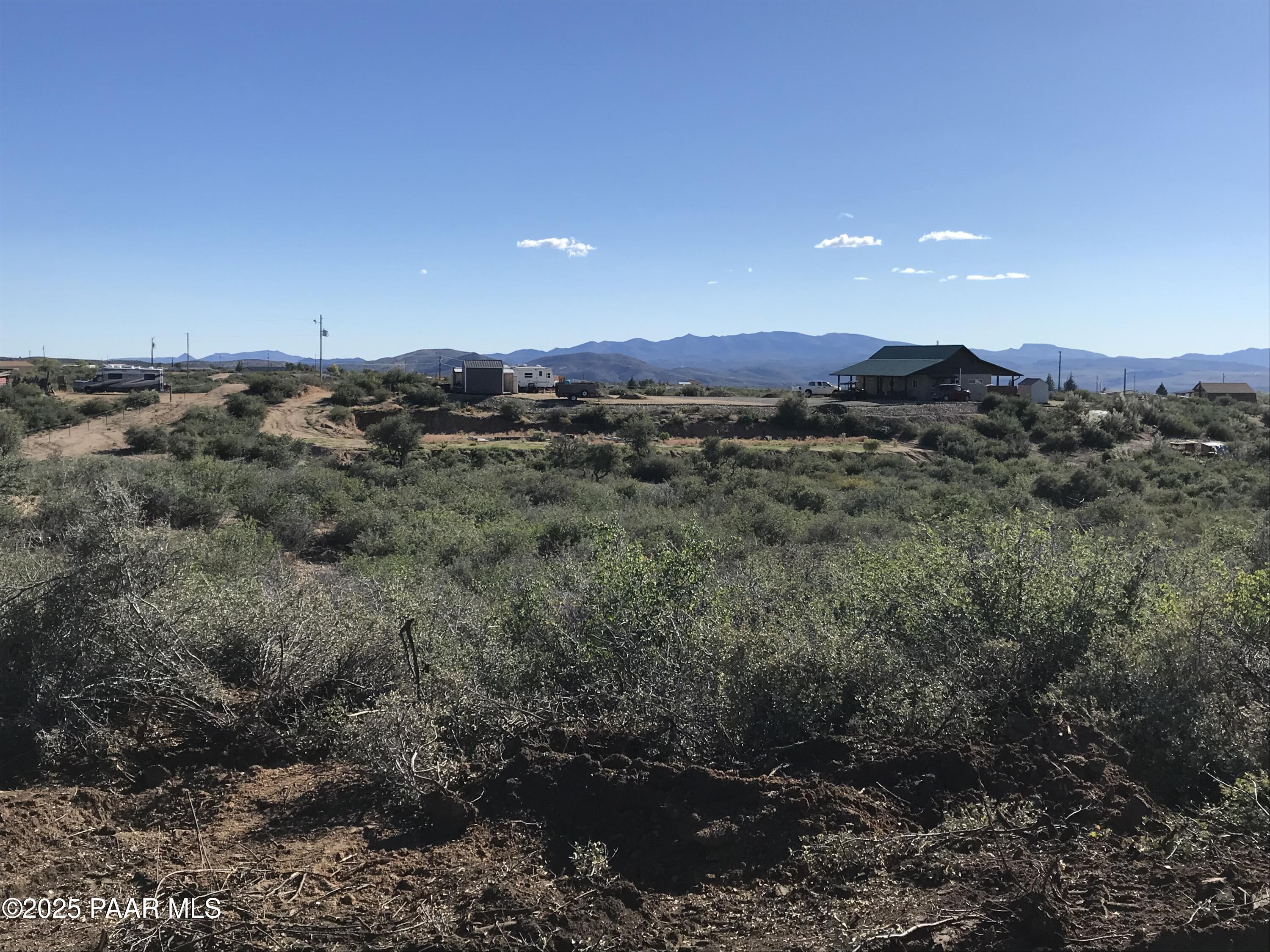 8335 West Barrington Road Wilhoit, AZ 86332 - Photo 8 of 13 a view of a dry yard with wooden floor and a mountain view