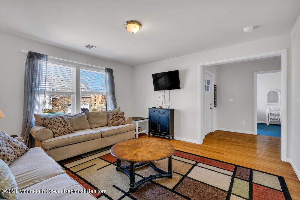 32 Niblick Street Point Pleasant Beach, NJ 08742 - Photo 17 of 38 a living room with furniture and a flat screen tv