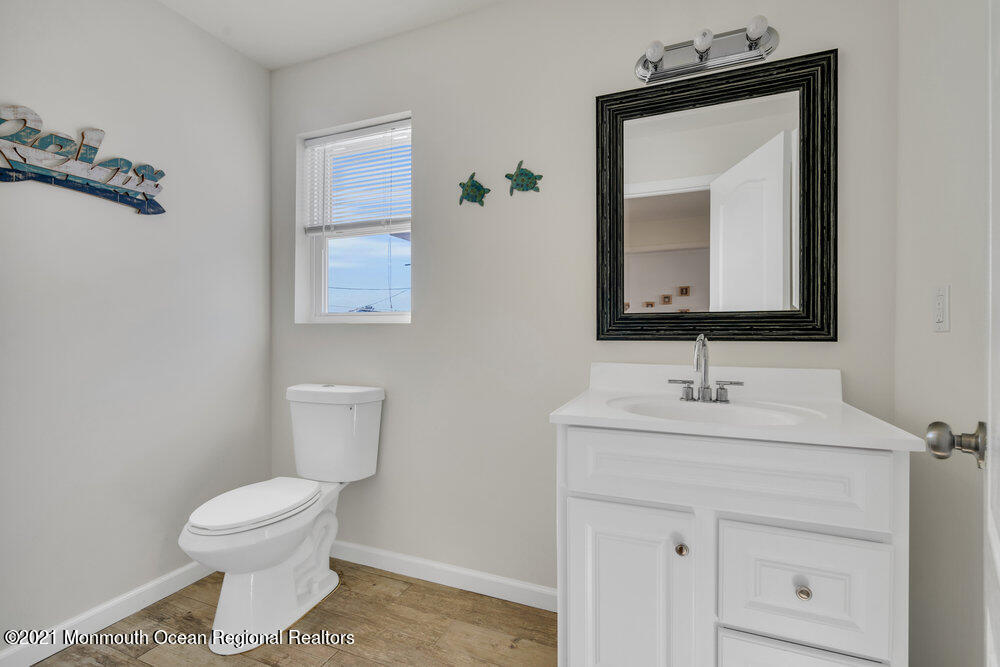 32 Niblick Street Point Pleasant Beach, NJ 08742 - Photo 20 of 38 a bathroom with a toilet sink and mirror