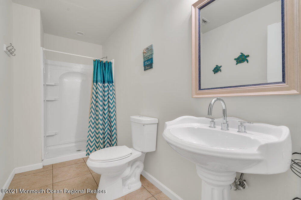 32 Niblick Street Point Pleasant Beach, NJ 08742 - Photo 23 of 38 a bathroom with a sink a toilet and shower