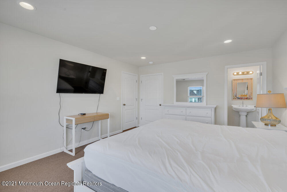 32 Niblick Street Point Pleasant Beach, NJ 08742 - Photo 24 of 38 a bedroom with a bed and a flat screen tv