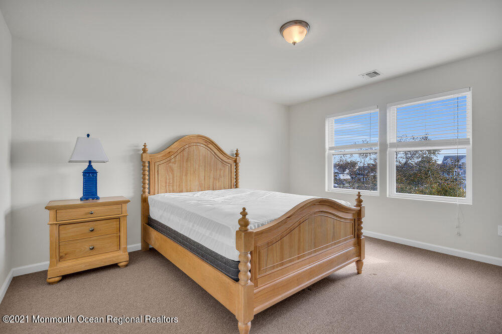 32 Niblick Street Point Pleasant Beach, NJ 08742 - Photo 27 of 38 a bed sitting in a bedroom next to a window