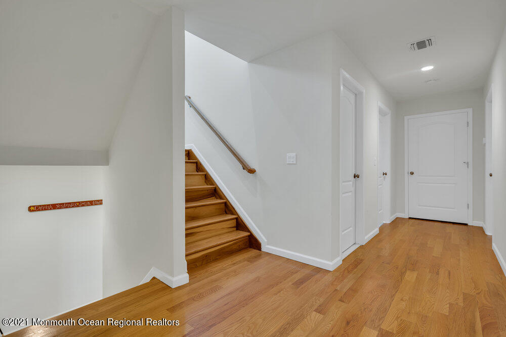 32 Niblick Street Point Pleasant Beach, NJ 08742 - Photo 31 of 38 a view of a hallway with wooden floor and staircase