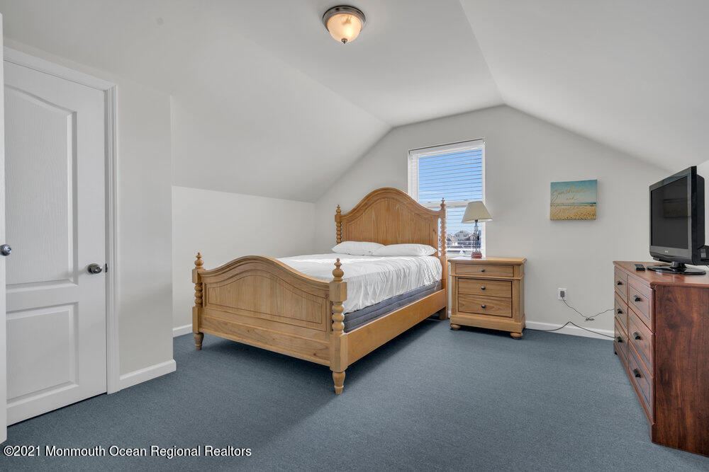32 Niblick Street Point Pleasant Beach, NJ 08742 - Photo 33 of 38 a bedroom with a bed and a flat tv screen on dresser