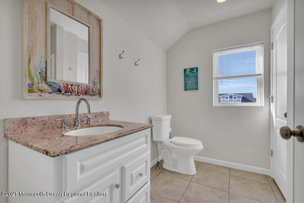 32 Niblick Street Point Pleasant Beach, NJ 08742 - Photo 36 of 38 a bathroom with a granite countertop sink and a mirror