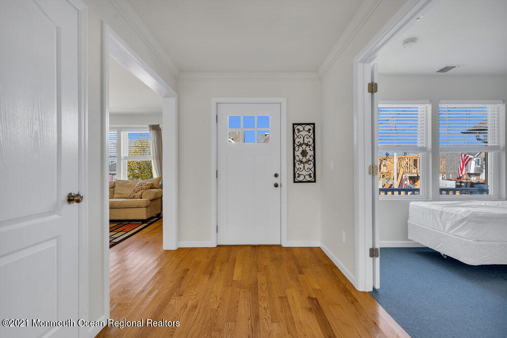 32 Niblick Street Point Pleasant Beach, NJ 08742 - Photo 8 of 38 a view of an empty room and bedroom with wooden floor