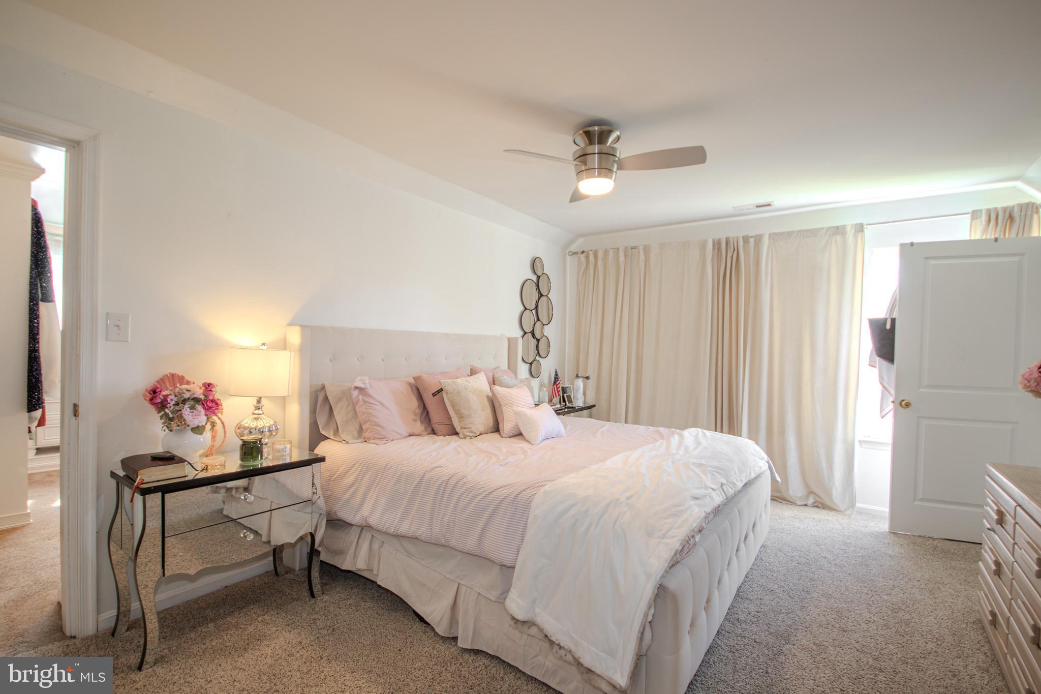 1519 Anchors Way Salisbury, MD 21801 - Photo 16 of 49 a bedroom with a bed and a chandelier