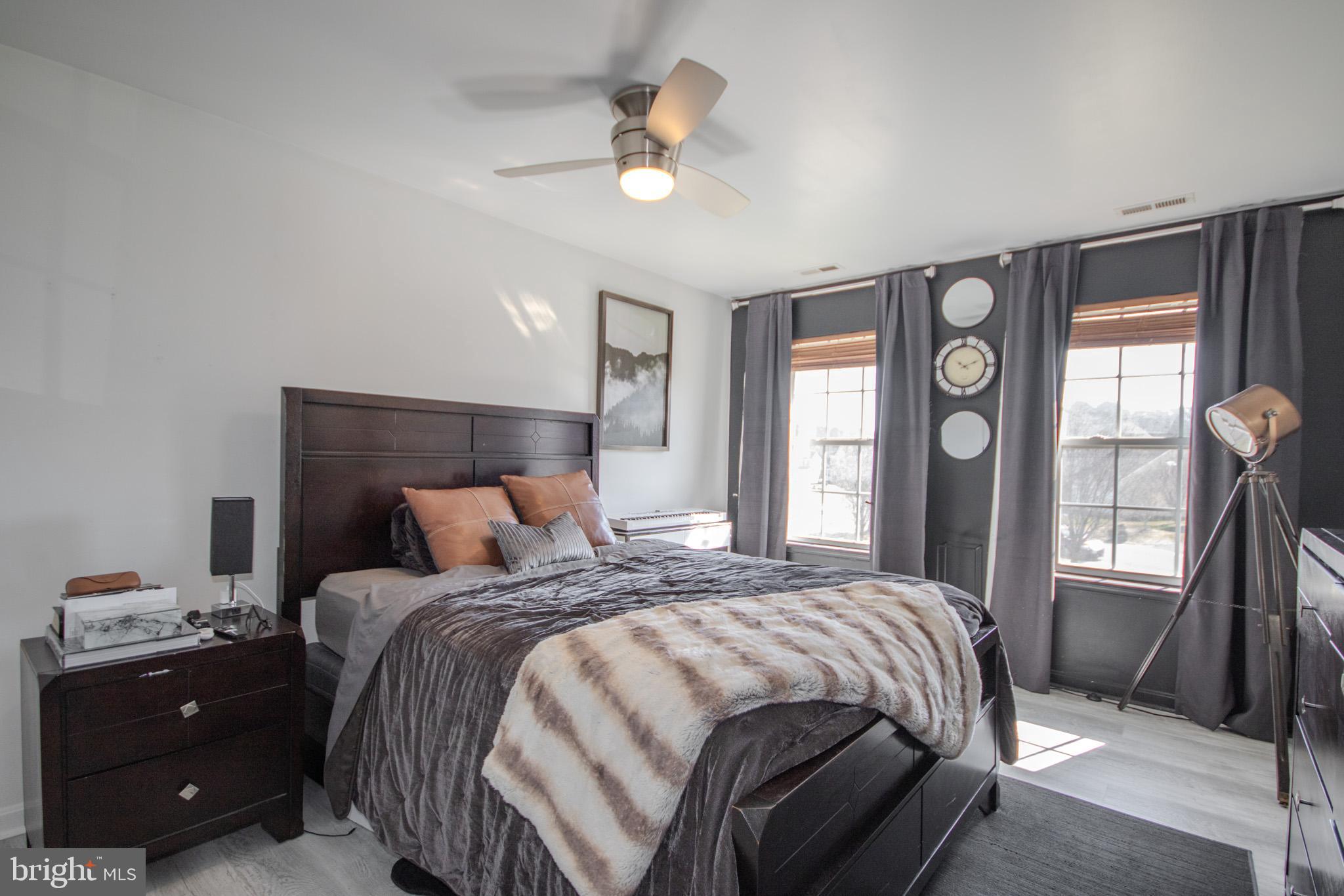 1519 Anchors Way Salisbury, MD 21801 - Photo 20 of 49 a bedroom with a bed a chandelier and a large window