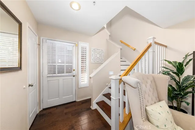 a view of entryway with wooden floor and stairs