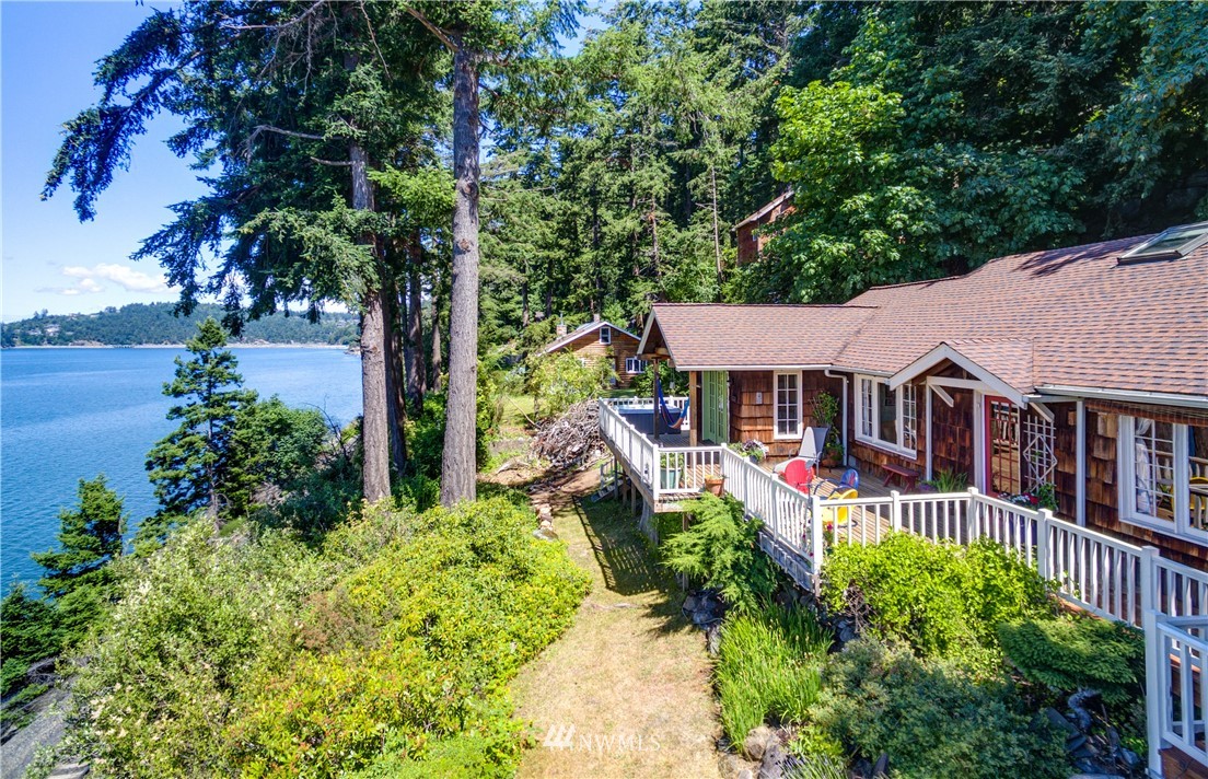 an aerial view of a house with swimming pool and garden