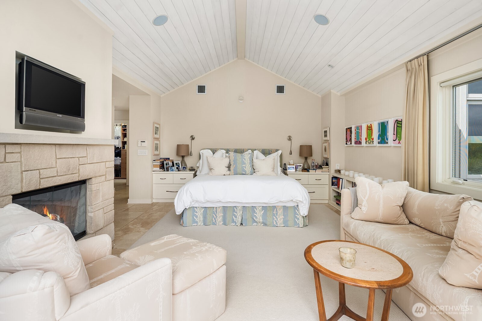 Undisclosed Address Seattle, WA 98112 - Photo 7 of 10 a bedroom with a bed and a flat screen tv