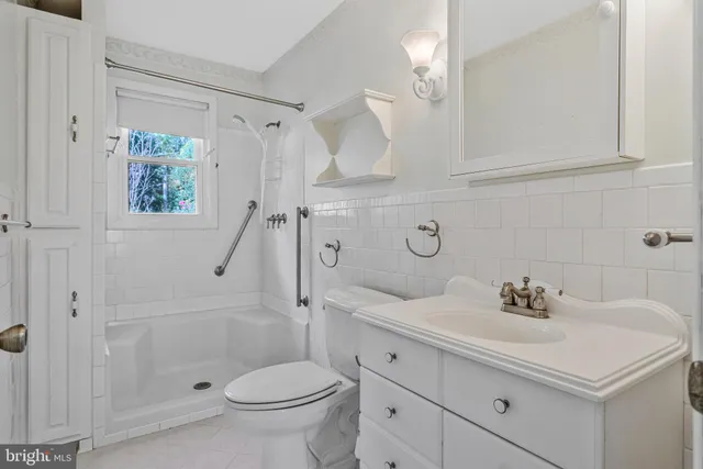 a view of a kitchen with a sink and a refrigerator