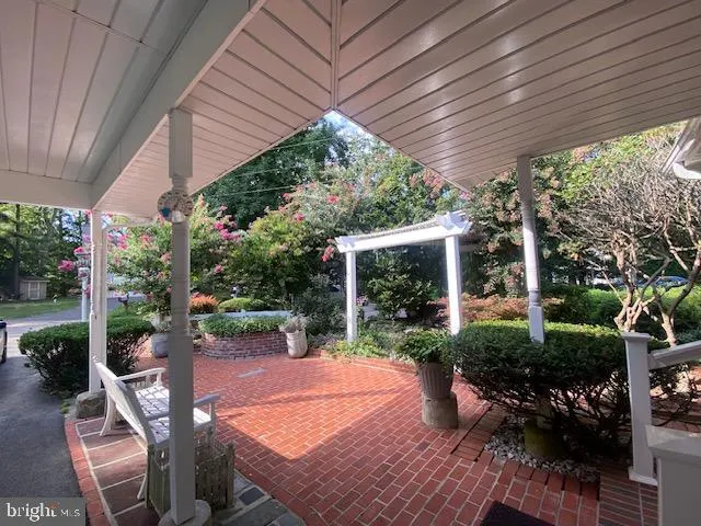 a view of an empty room with stairs and a window