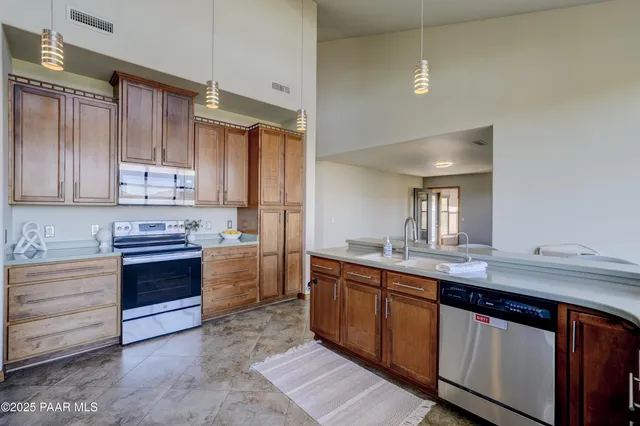 a kitchen with stainless steel appliances granite countertop a sink and cabinets