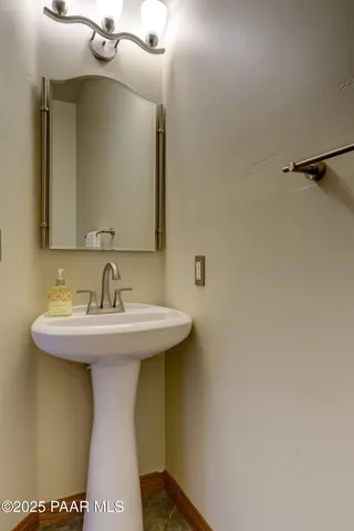 a bathroom with a sink and mirror
