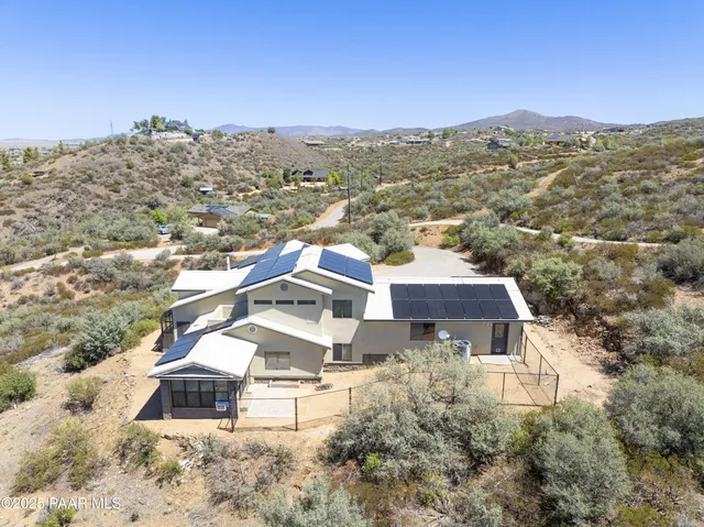 an aerial view of residential houses with a city view