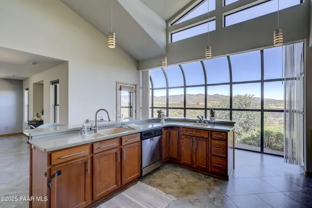 a kitchen with a sink and large cabinets