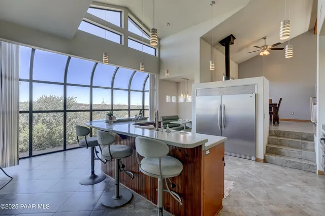 a kitchen with a dining table chairs and chandelier