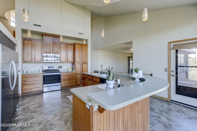 a kitchen with stainless steel appliances stove microwave and cabinets