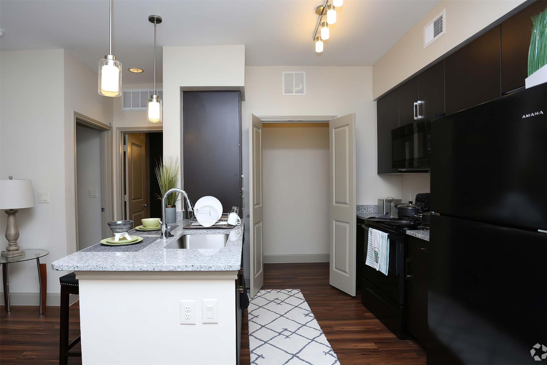 4604 Cypresswood Drive, Unit 1104 Spring, TX 77379 - Photo 11 of 29 a kitchen with granite countertop a stove a sink and a refrigerator