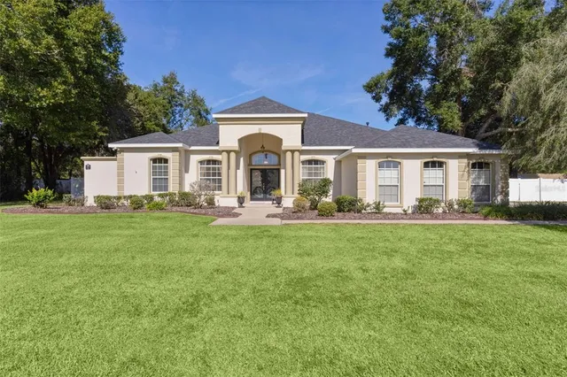 a front view of a house with a yard porch and furniture