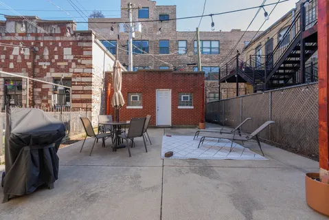 a building outdoor space with patio furniture and potted plants