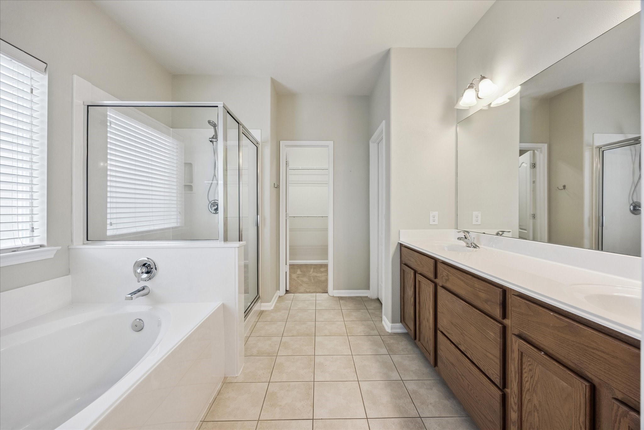 8506 Sweetstone Field Court Cypress, TX 77433 - Photo 17 of 33 a bathroom with a tub a sink and a large mirror