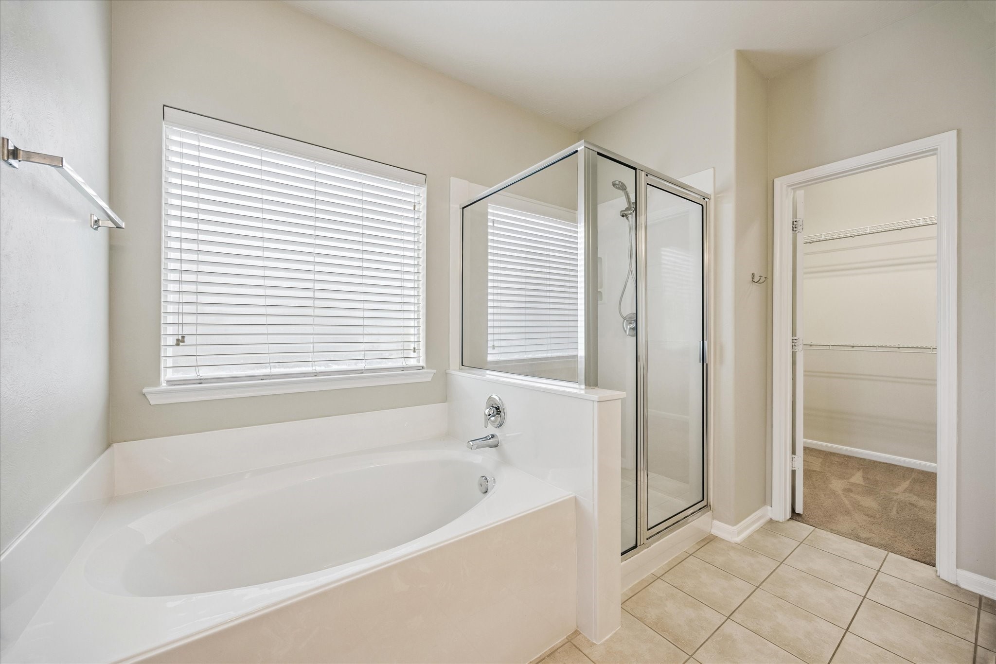 8506 Sweetstone Field Court Cypress, TX 77433 - Photo 18 of 33 a bathroom with a bathtub and a shower