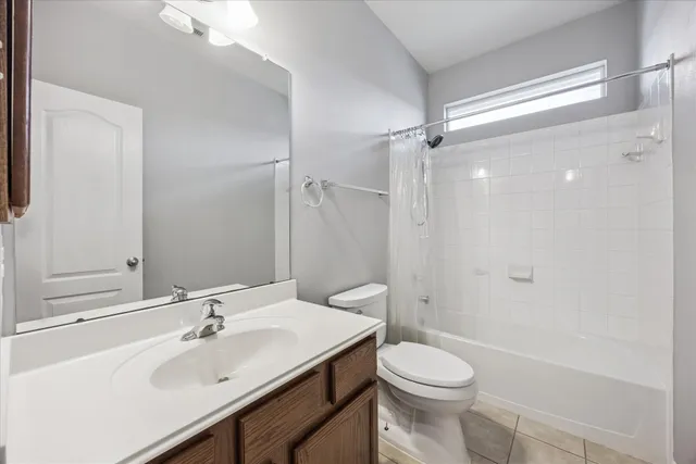 a bathroom with a sink toilet mirror and shower