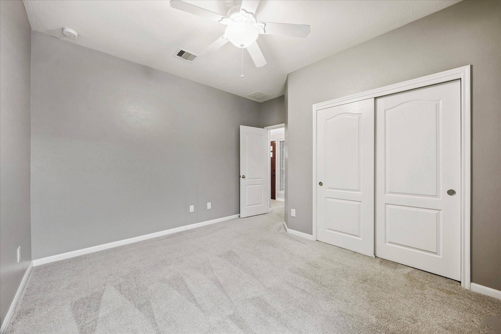 8506 Sweetstone Field Court Cypress, TX 77433 - Photo 24 of 33 an empty room with chandelier fan and closet area