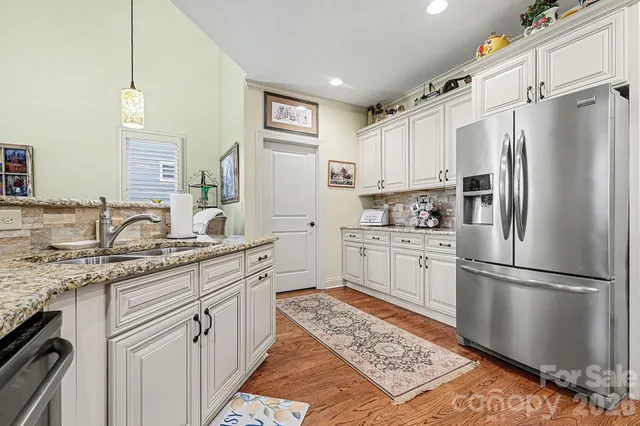 a bathroom with a bathtub a sink and a large window