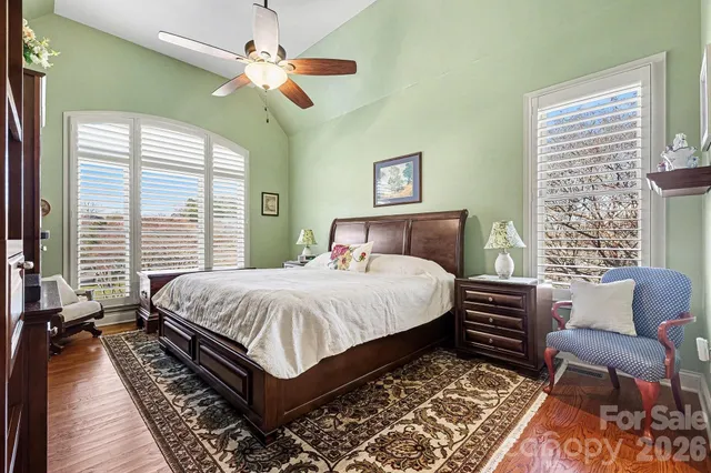 a bedroom with a large bed and a chandelier