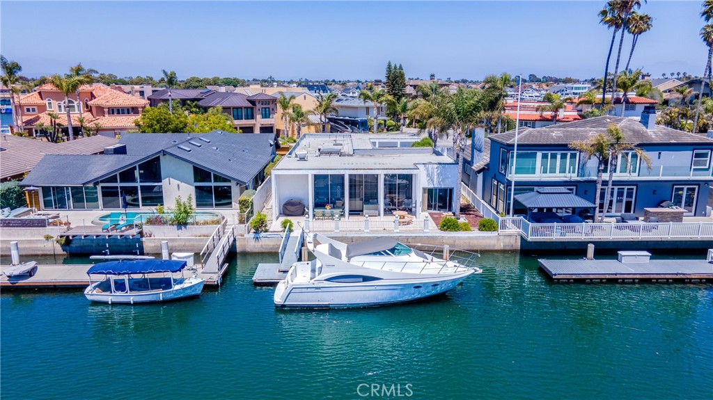 a front view of a house with swimming pool garden and lake view