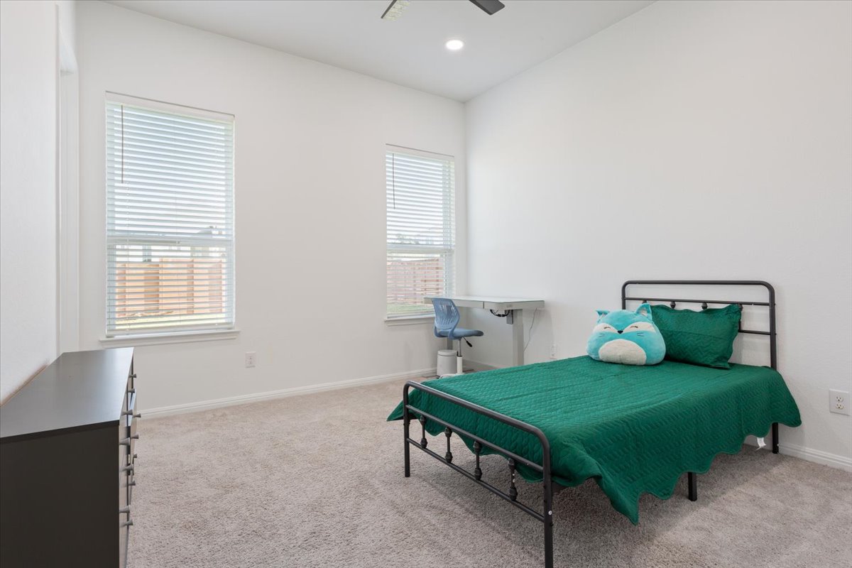 3625 Garrano Bend Leander, TX 78641 - Photo 23 of 38 Natural light filters through ample windows in this versatile secondary bedroom, perfect for rest or study.