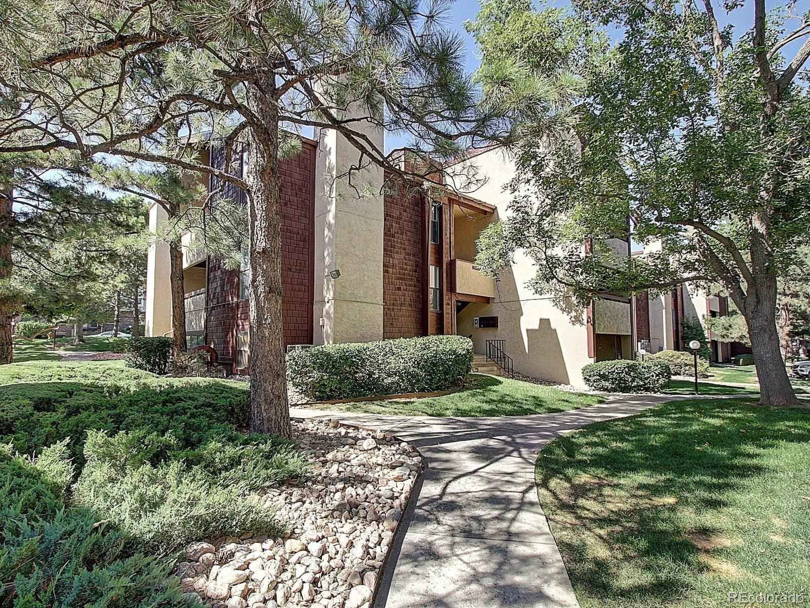 a brick house with trees in front of it