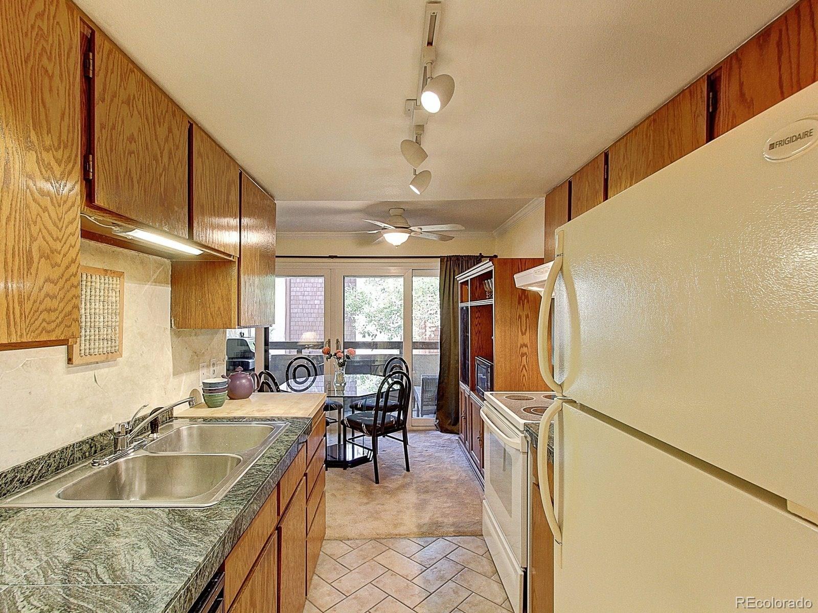 6410 South Dayton Street, Unit I08 Englewood, CO 80111 - Photo 13 of 32 a very nice looking room with a large window and furniture