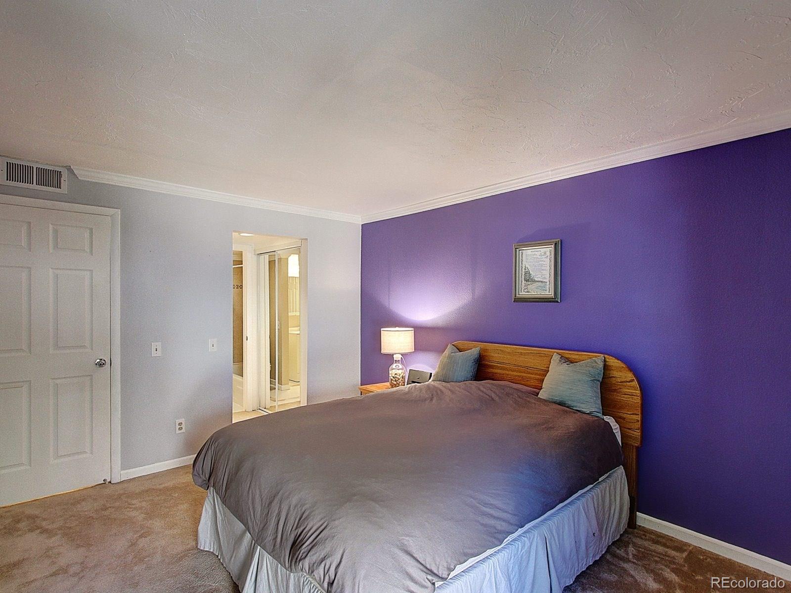 6410 South Dayton Street, Unit I08 Englewood, CO 80111 - Photo 18 of 32 a bedroom with a bed and window